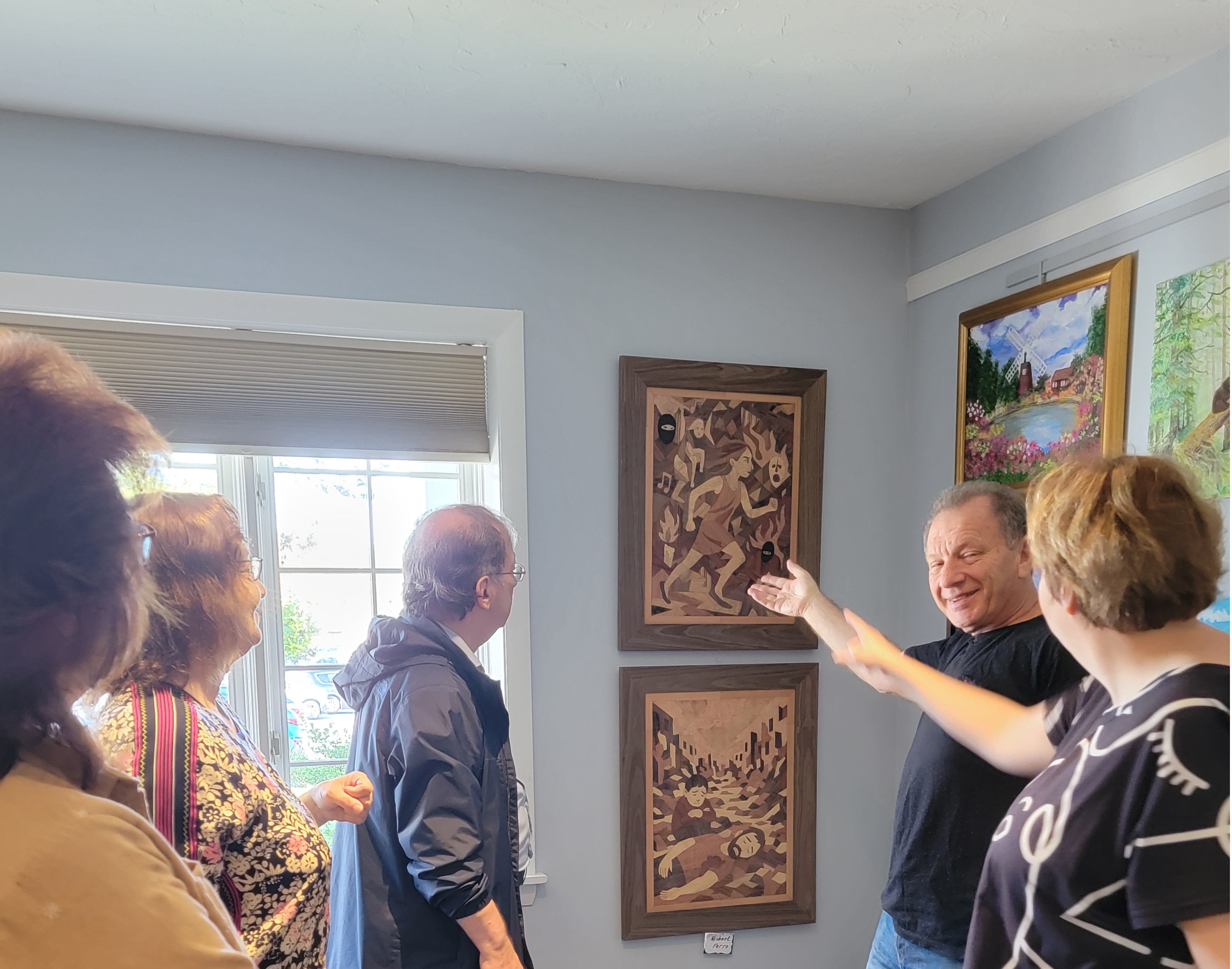 Photo from my exhibition showing people viewing marquetry works
